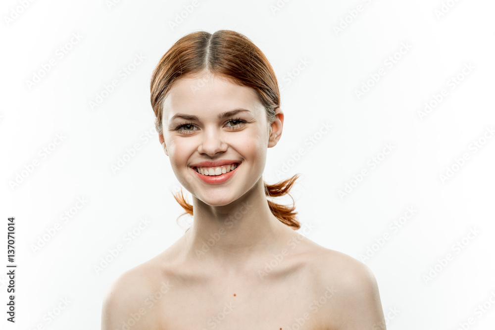 naked smiling red-haired woman on a light background naked smiling red-haired woman on a light background