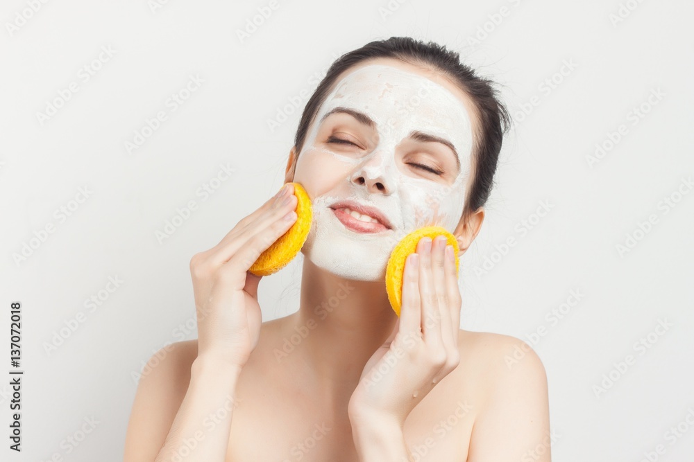 adorable woman with a sponge near the face