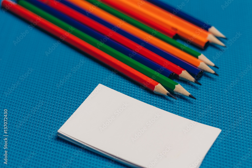 multicolored pencils and business cards multicolored pencils and business cards