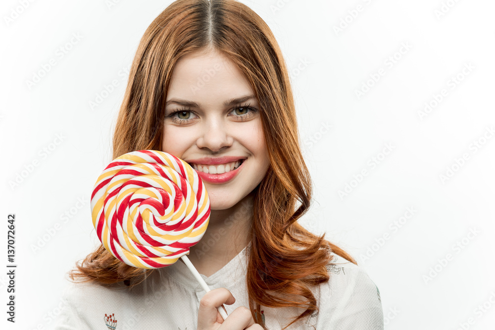 round lollipop in the hands of a happy woman