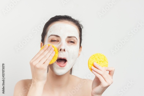 happy woman with a sponge near his face...