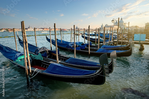 Venetian gondolas at sunset © Givaga