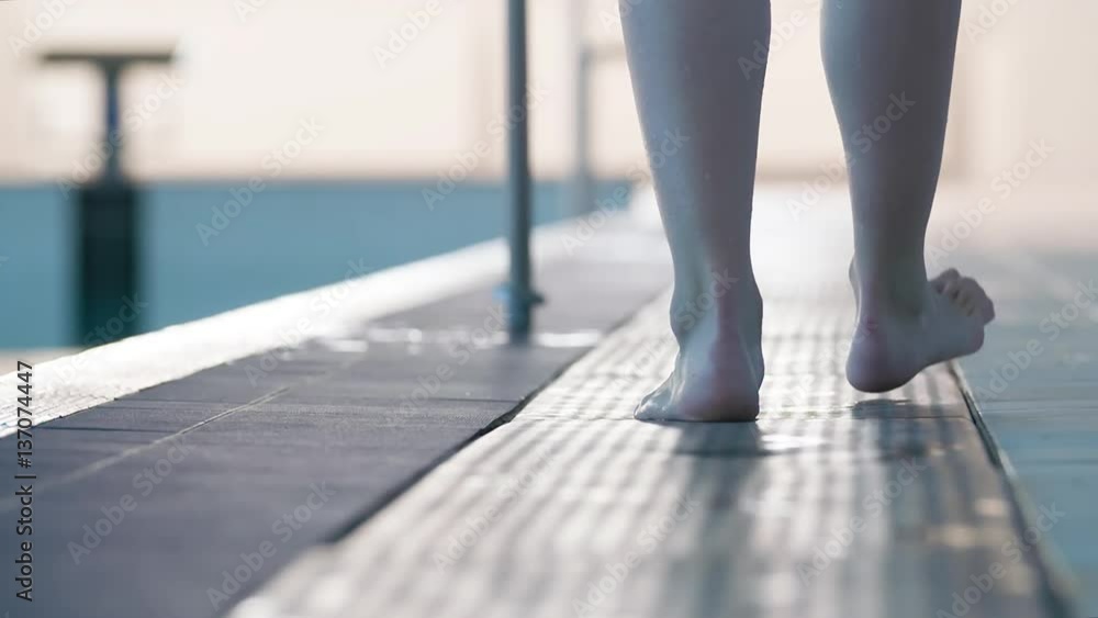 Female swimmer barefoot leg foots walking on swimming pool rubber ...