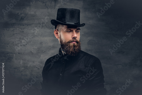 Brutal bearded male over grey background.