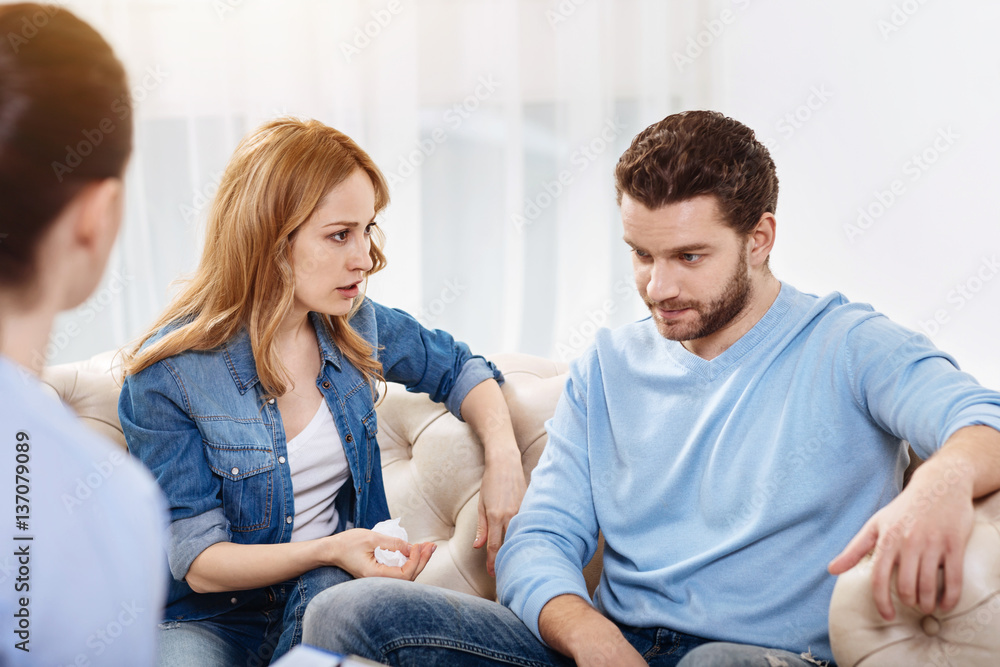 Pleasant cheerless woman looking at the husband Pleasant cheerless woman looking at the husband
