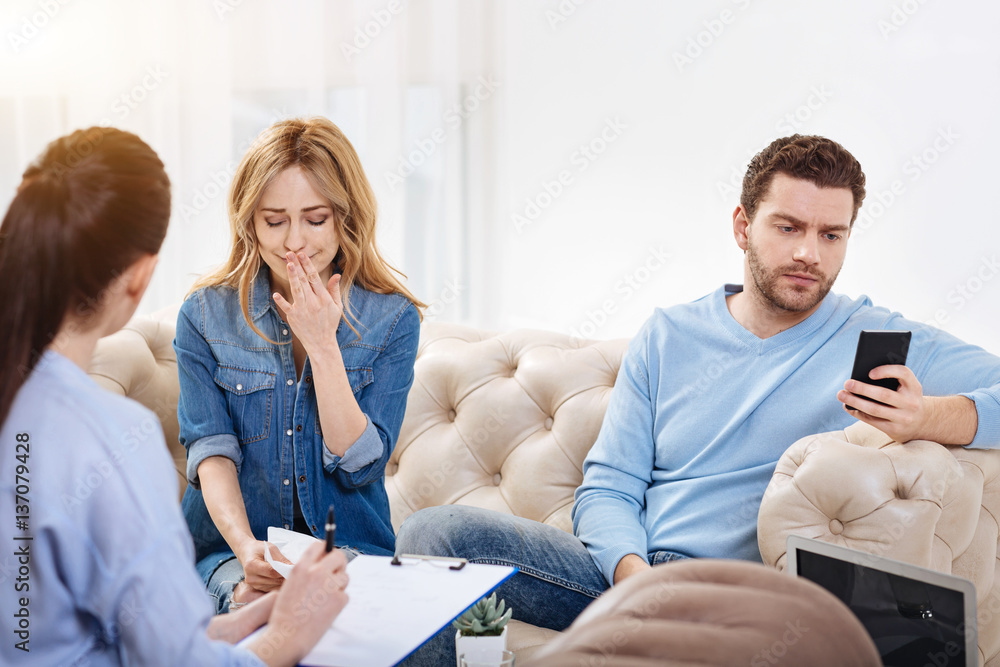 Nice serious man looking at his smartphone screen Nice serious man looking at his smartphone screen