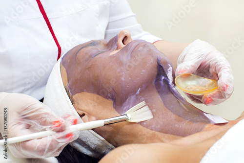 Process of massage and facials in beauty salon 