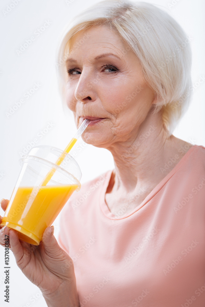 Enigmatical pretty blonde drinking fresh orange juice Enigmatical pretty blonde drinking fresh orange juice