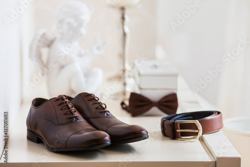 Brown leather men's shoes with belt, bow-tie. Set groom accessories.
