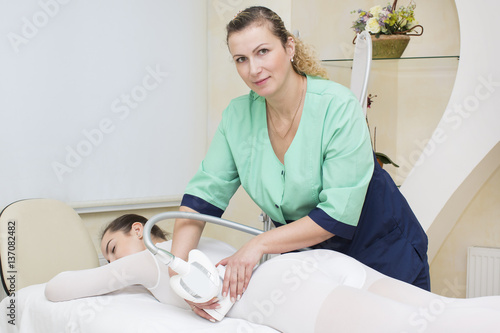 Woman is in the process at the clinic lipomassage 