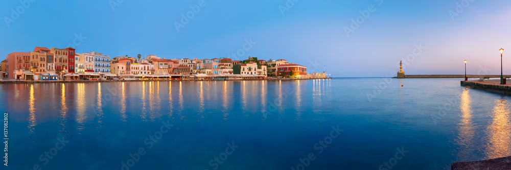 Fototapeta premium Picturesque panoramic view of old harbour with Lighthouse of Chania at sunrise, Crete, Greece