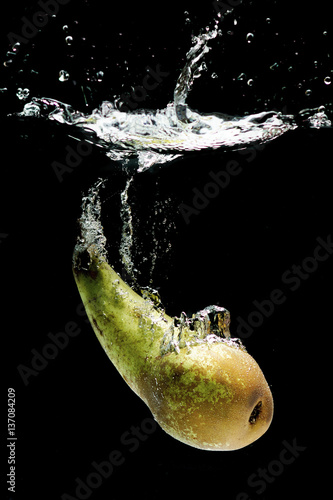 fresh pear dropped into water