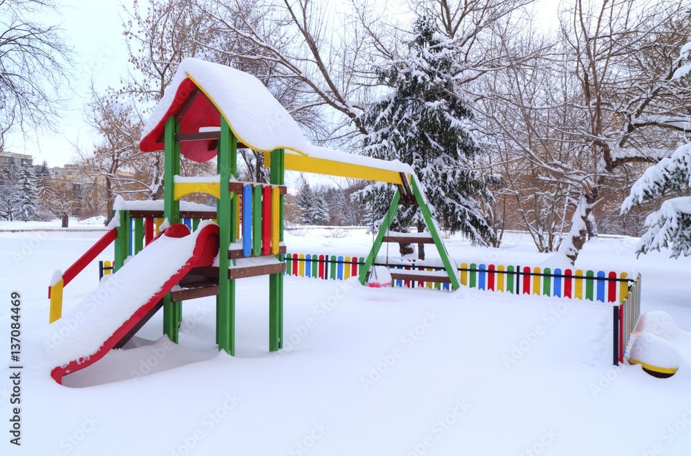 Fototapeta premium Children's playground covered with snow in winter