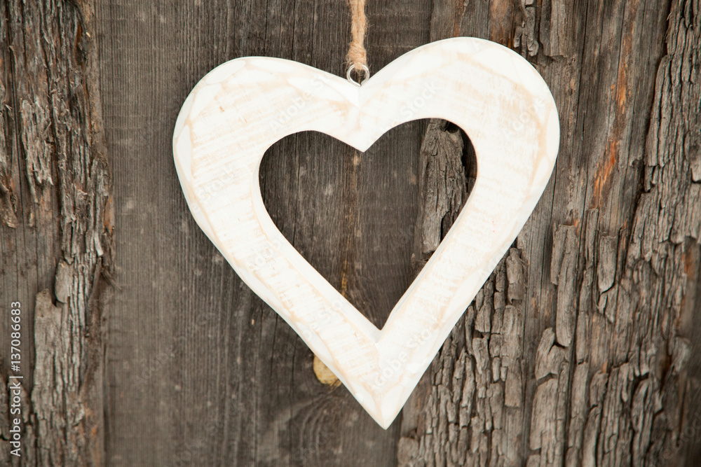 White heart on rustic wooden background White heart on rustic wooden background