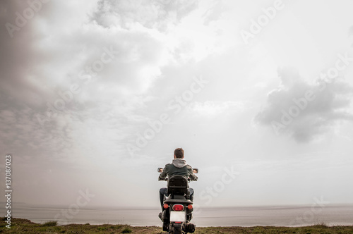 Sitting on the motorbike near sea