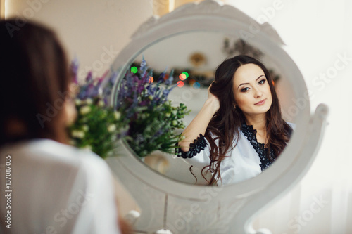 The charming lady looking at mirror photo