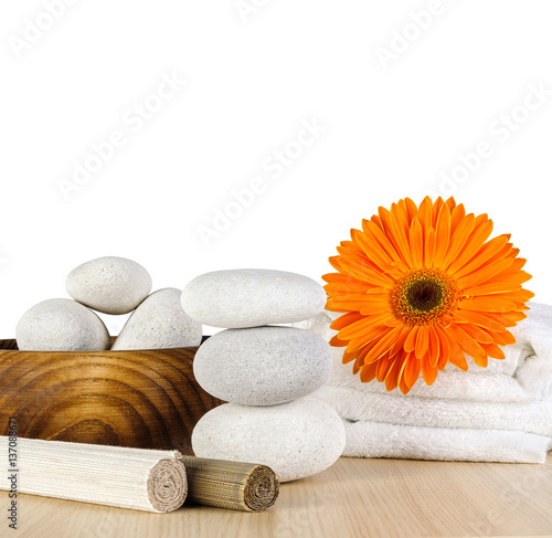 Spa concept / Spa decoration with orange Gerbera daisy, towel and spa stones