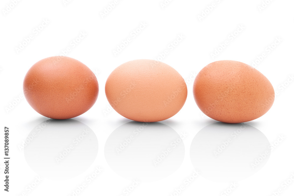 Three brown chicken eggs for cooking. Profile shot. Isolated on white background with shadow reflection. Three brown chicken eggs for baking, on white background. Three eggs to kitchen. Three eggs Three brown chicken eggs for cooking. Profile shot. Isolated on white background with shadow reflection. Three brown chicken eggs for baking, on white background. Three eggs to kitchen. Three eggs