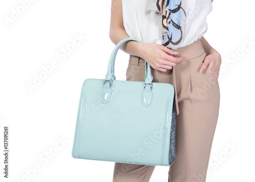 Woman holds beautiful blue purse isolated on white background