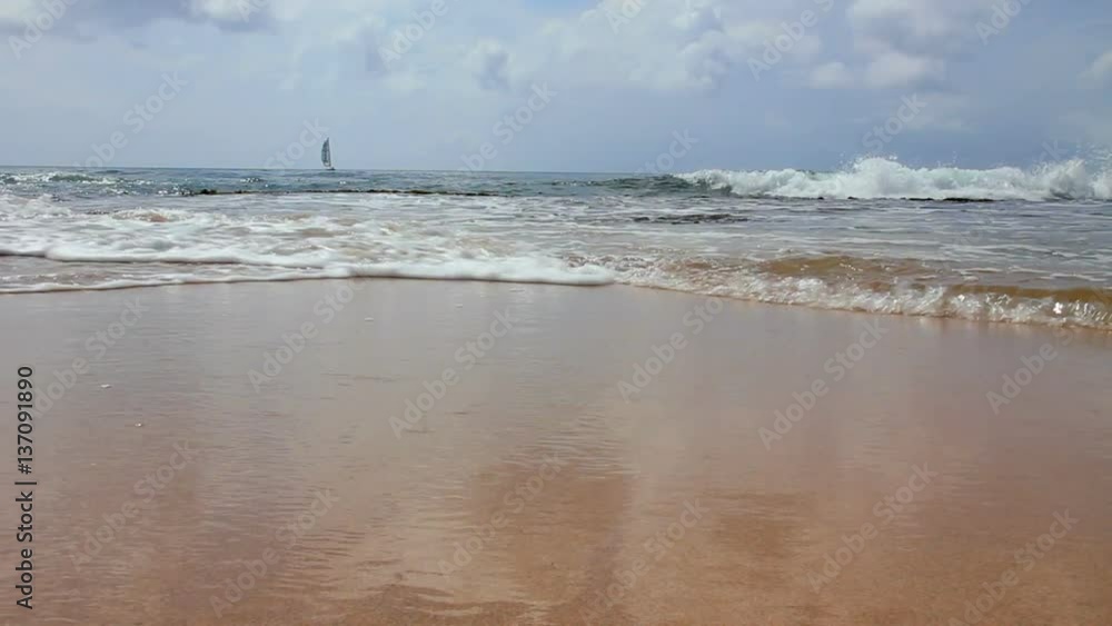 Low angle of waves crashing on a beach. Low angle of waves crashing on a beach.