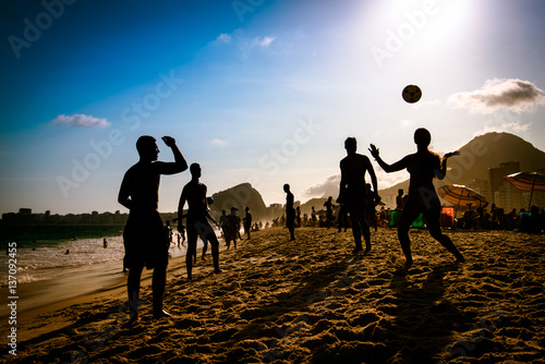 Silhouettes of Brazilians Playing Beach Footbal in Copacabana by Sunset
