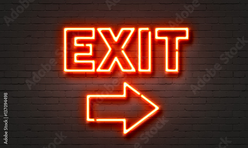 Exit neon sign on brick wall background. photo