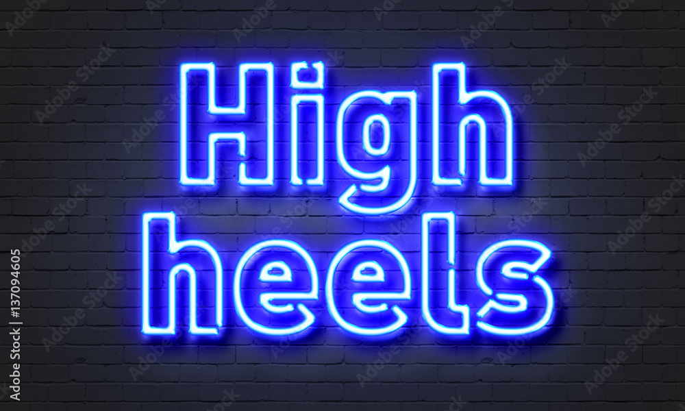 High heels neon sign on brick wall background.
