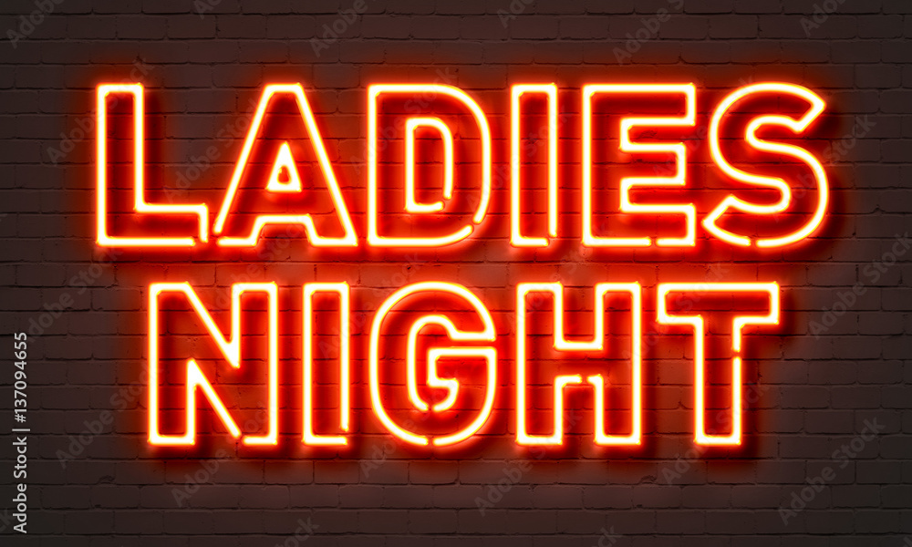 Ladies night neon sign on brick wall background.