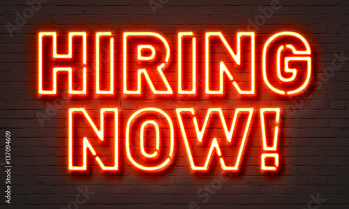 Canvas Print Hiring now neon sign on brick wall background.