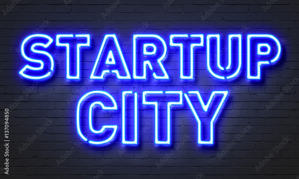 Startup city neon sign on brick wall background. Startup city neon sign on brick wall background.