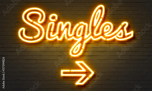 Singles neon sign on brick wall background. photo