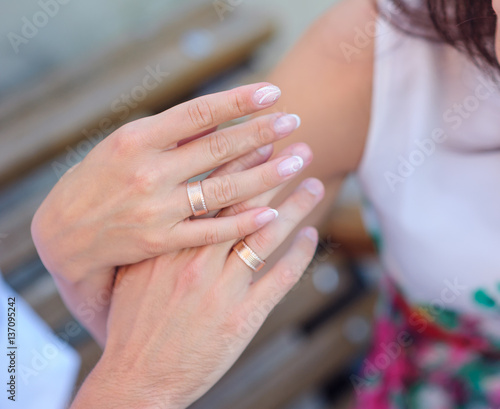 hands of bride and groom with gold rings