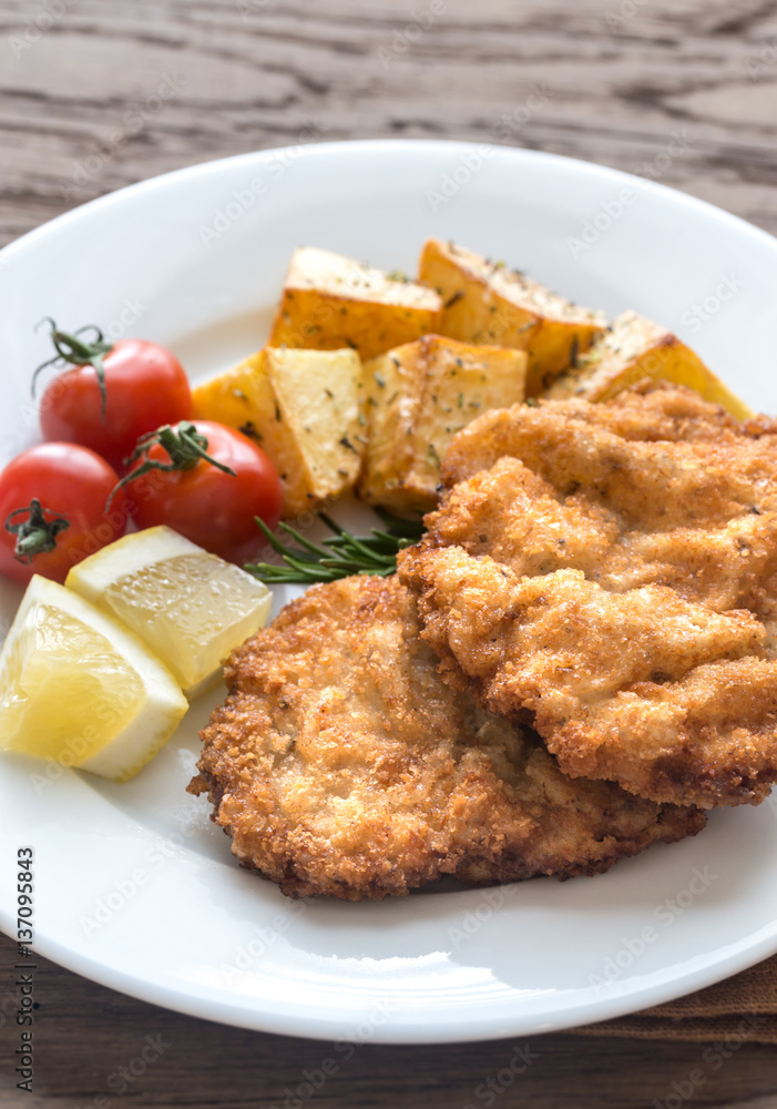 Portion of schnitzel with garnish Portion of schnitzel with garnish