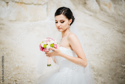 Bride with a bouquet, smiling. Wedding portrait of beautiful bride. Wedding. Wedding day.