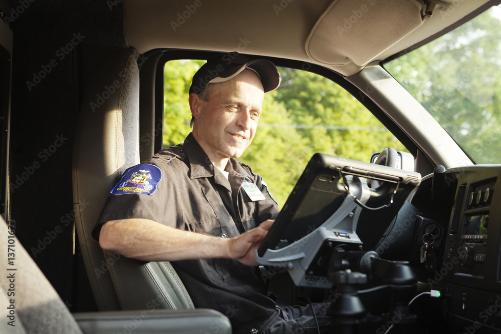 Emergency medical technician working in ambulance Emergency medical technician working in ambulance