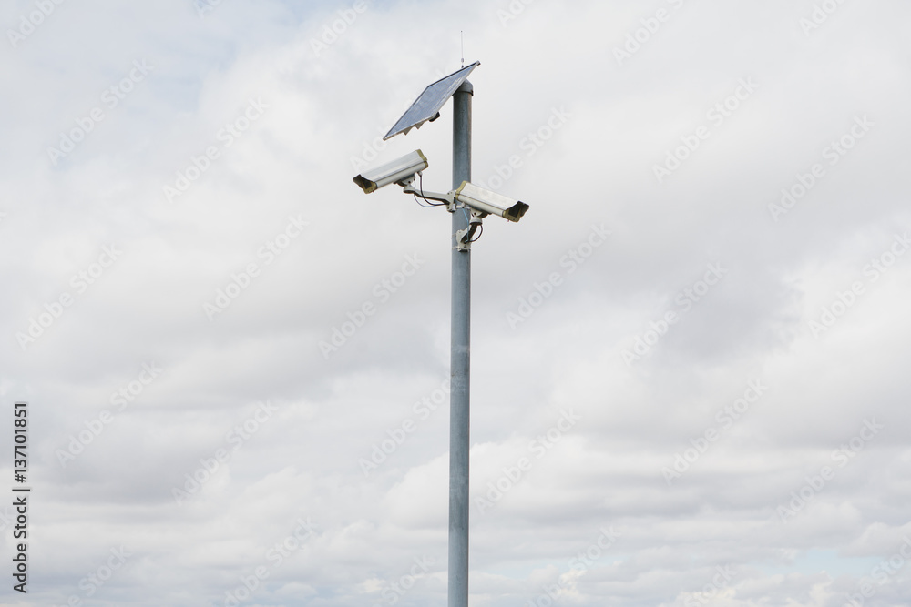 A solar powered surveillance camera on a pole. A solar powered surveillance camera on a pole.