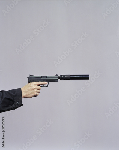 Hand aiming gun with silencer photo