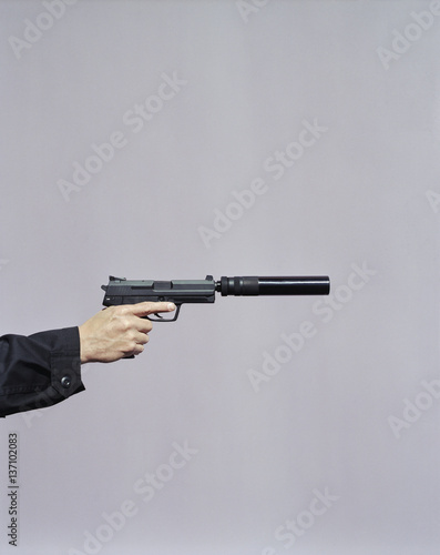 Hand aiming gun with silencer