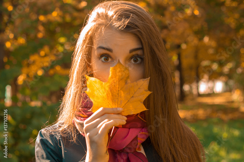 Portrait of a young girl which closed Roth leaf close-up