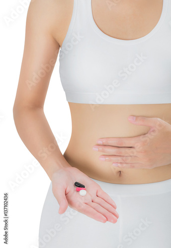 Woman beautiful, healthy body shape and holding group of medicine black red white capsule color on the belly, assistance concept, isolated on white background