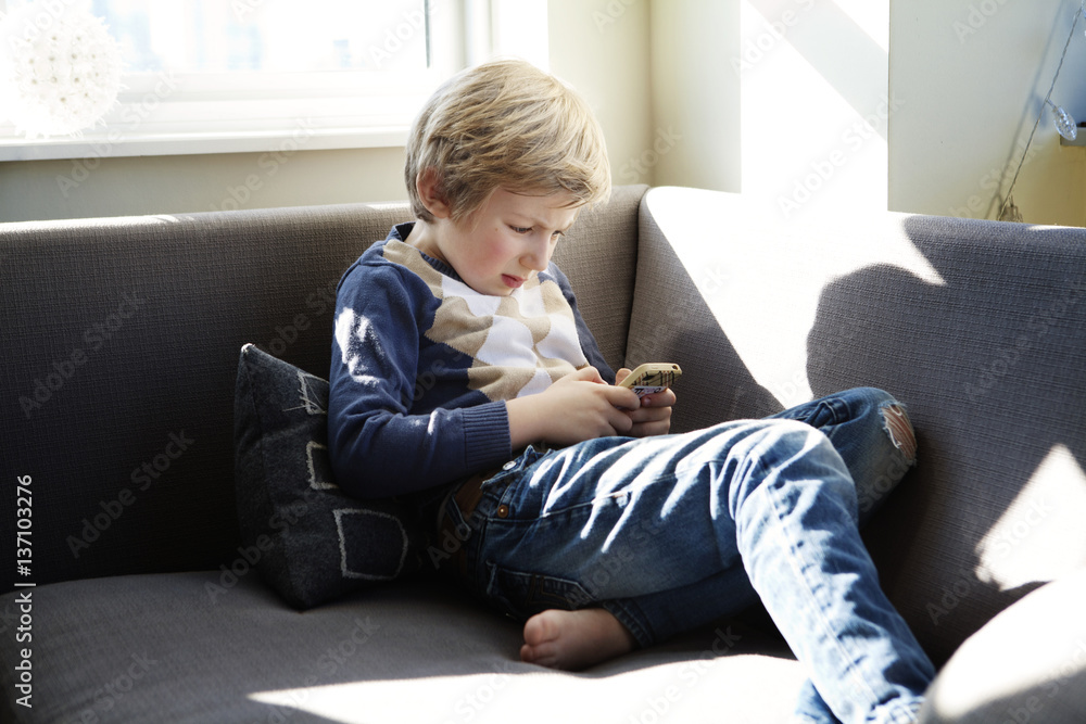 Boy (6-7) using mobile phone Boy (6-7) using mobile phone