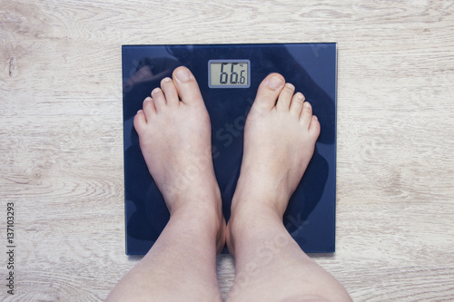 Feet on scales. Excess weight photo