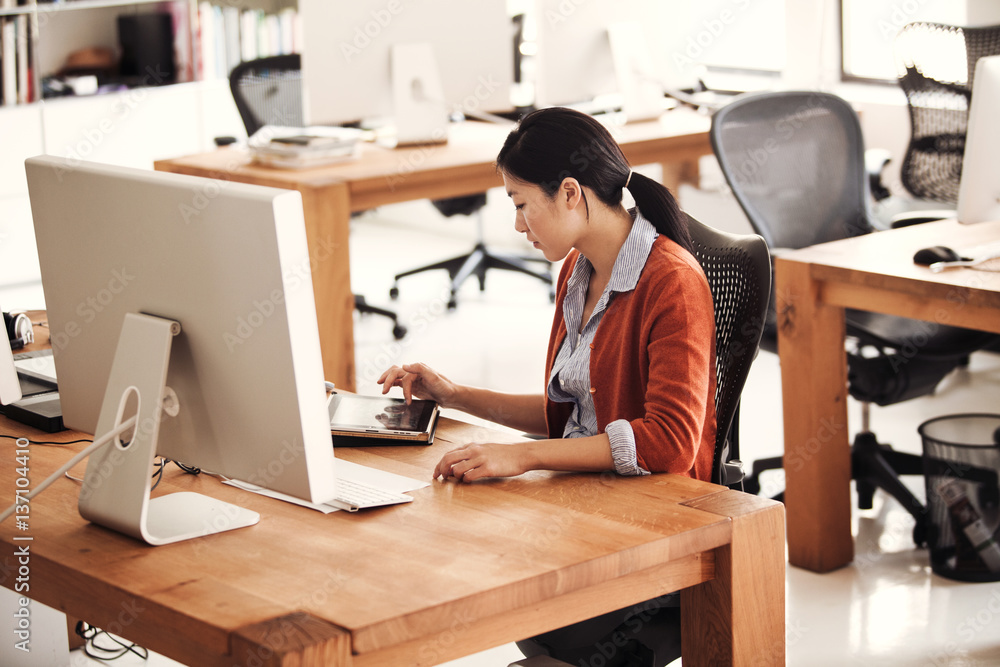 Businesswoman working at desk in office Businesswoman working at desk in office