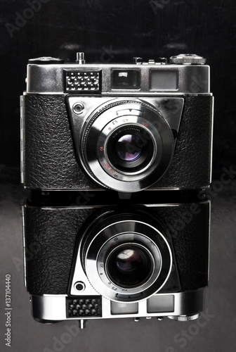 Old film vintage film camera on a black background