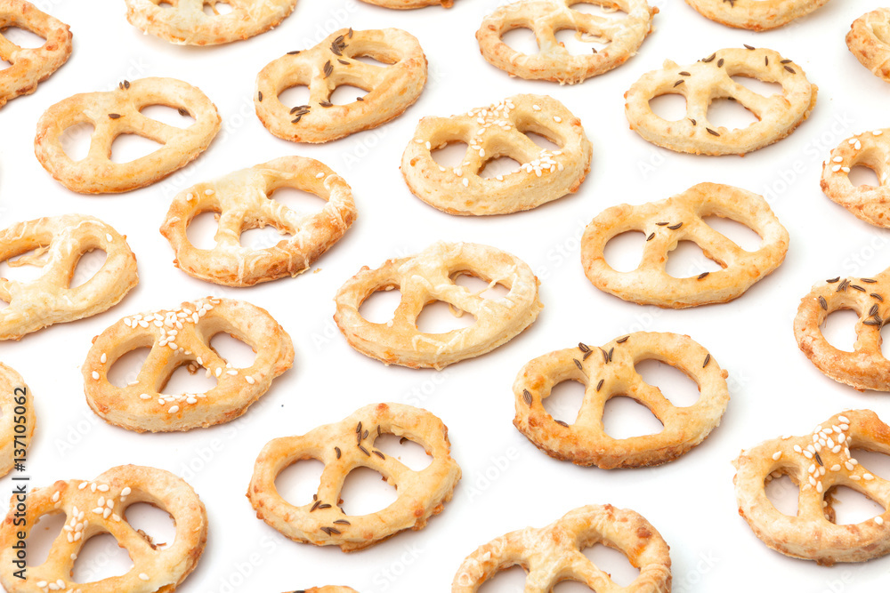 Salted crunchy handmade pastry on white background. Christmas pastry. New Year's pastry. Salted pretzels with cumin and sesame and cheese. Typical party or holiday cracknels. Typical european delicacy