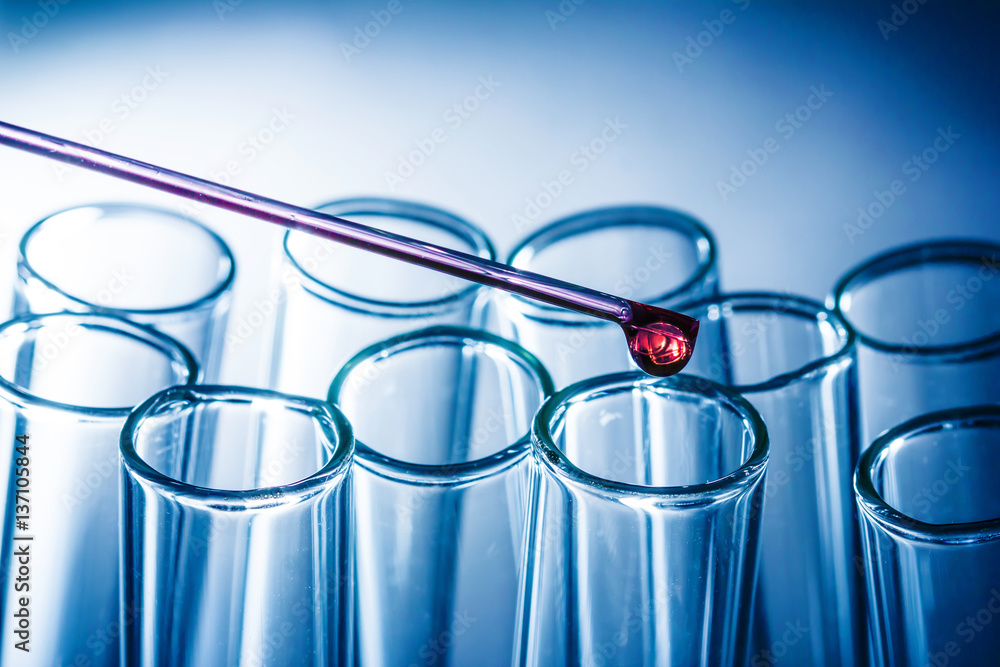 Red drop fluid falling down to glass flask. Chemistry and science background. Red drop fluid falling down to glass flask. Chemistry and science background.