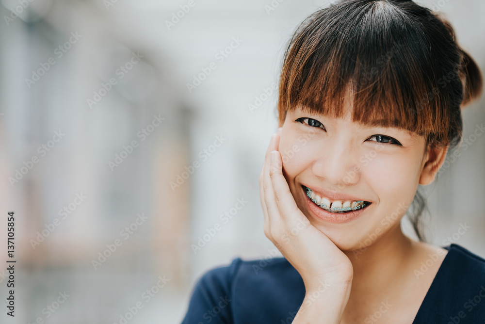 Portrait of happy young pretty Asian girl with braces smiling. Portrait of happy young pretty Asian girl with braces smiling.