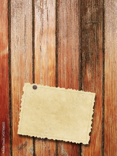 Single blank old vintage postcard with pin on brown weathered wooden boards background