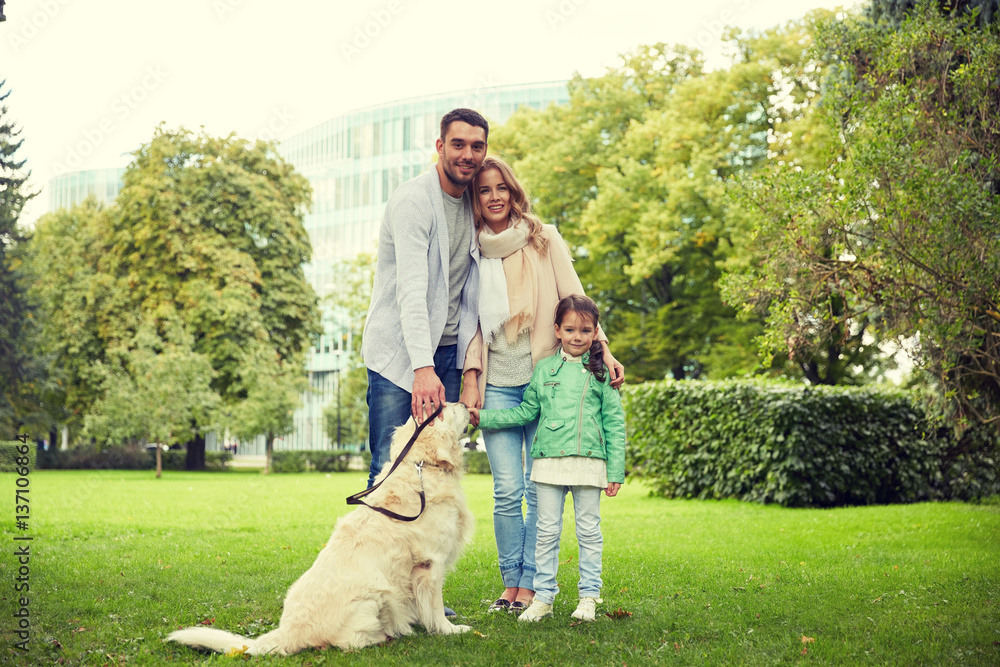happy family with labrador retriever dog in park
