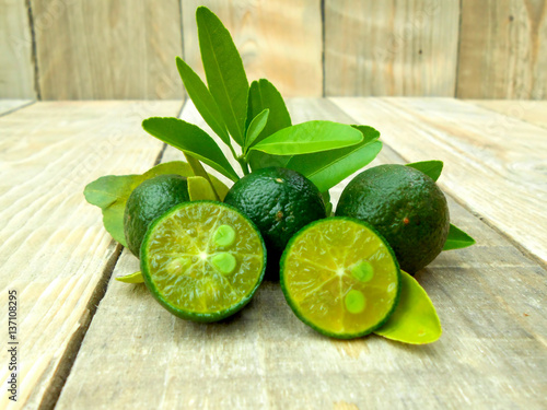 Calamansi isolated on wooden background